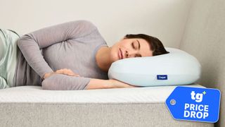 A woman sleeping on a Casper Hybrid Pillow with Snow Technology, with a Tom's Guide 'PRICE DROP' badge overlaid