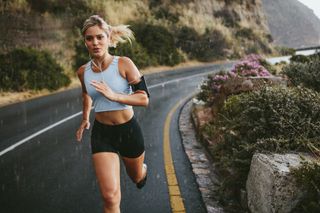 a female runner running on a road