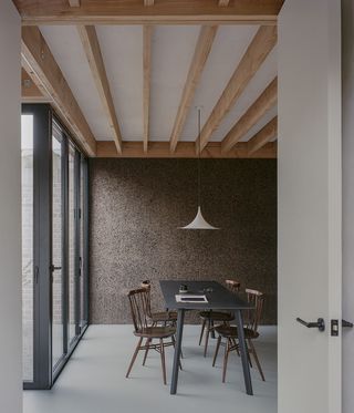 dining space with cork wall in background