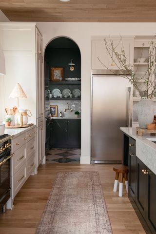 a light kitchen with a dark pantry