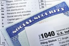 A pile of papers including a Social Security card and tax form.