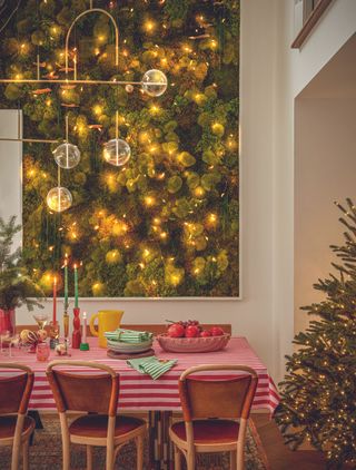 A red striped tablecloth set with Christmas decorations