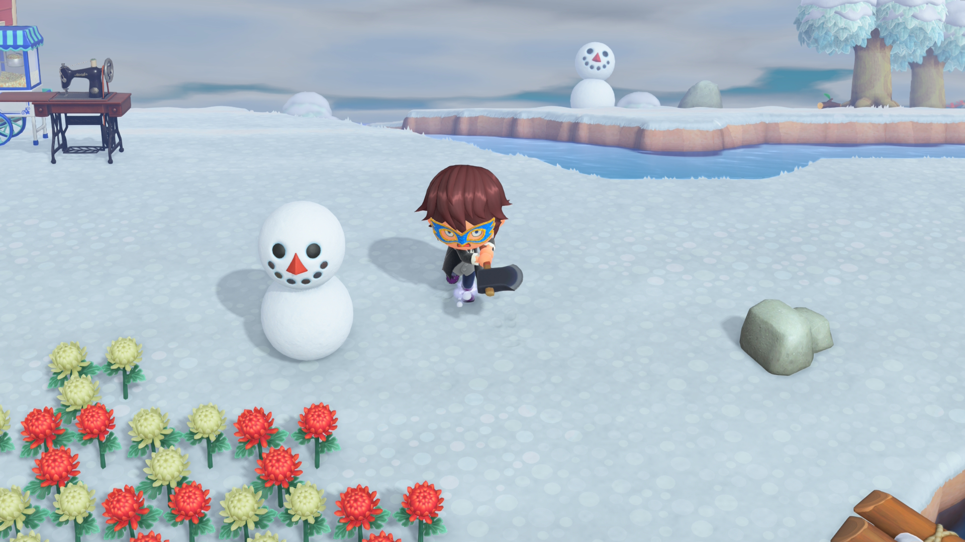 The player swipes an axe near a snowboy in the winter village in Animal Crossing: New Horizons - Nintendo Switch 2 Edition