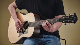 Man playing Taylor acoustic guitar