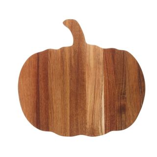 A dark wooden cutting board in pumpkin shape