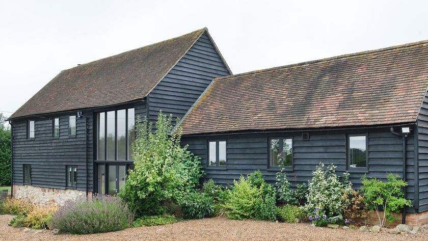 black timber clad barn conversion with double and single storey sections