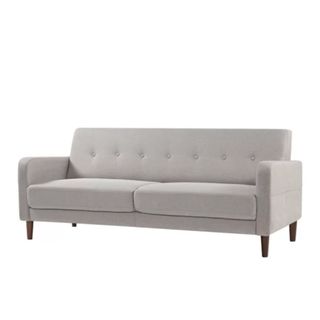 A gray couch with a tufted back