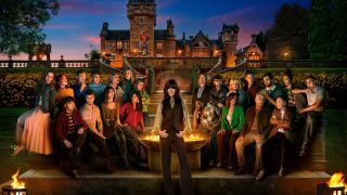 A wide shot of the cast of The Traitors Season 4 UK along with host Claudia Winkleman, photographed against stately Ardross Castle in Scotland as night falls and the carnage begins.