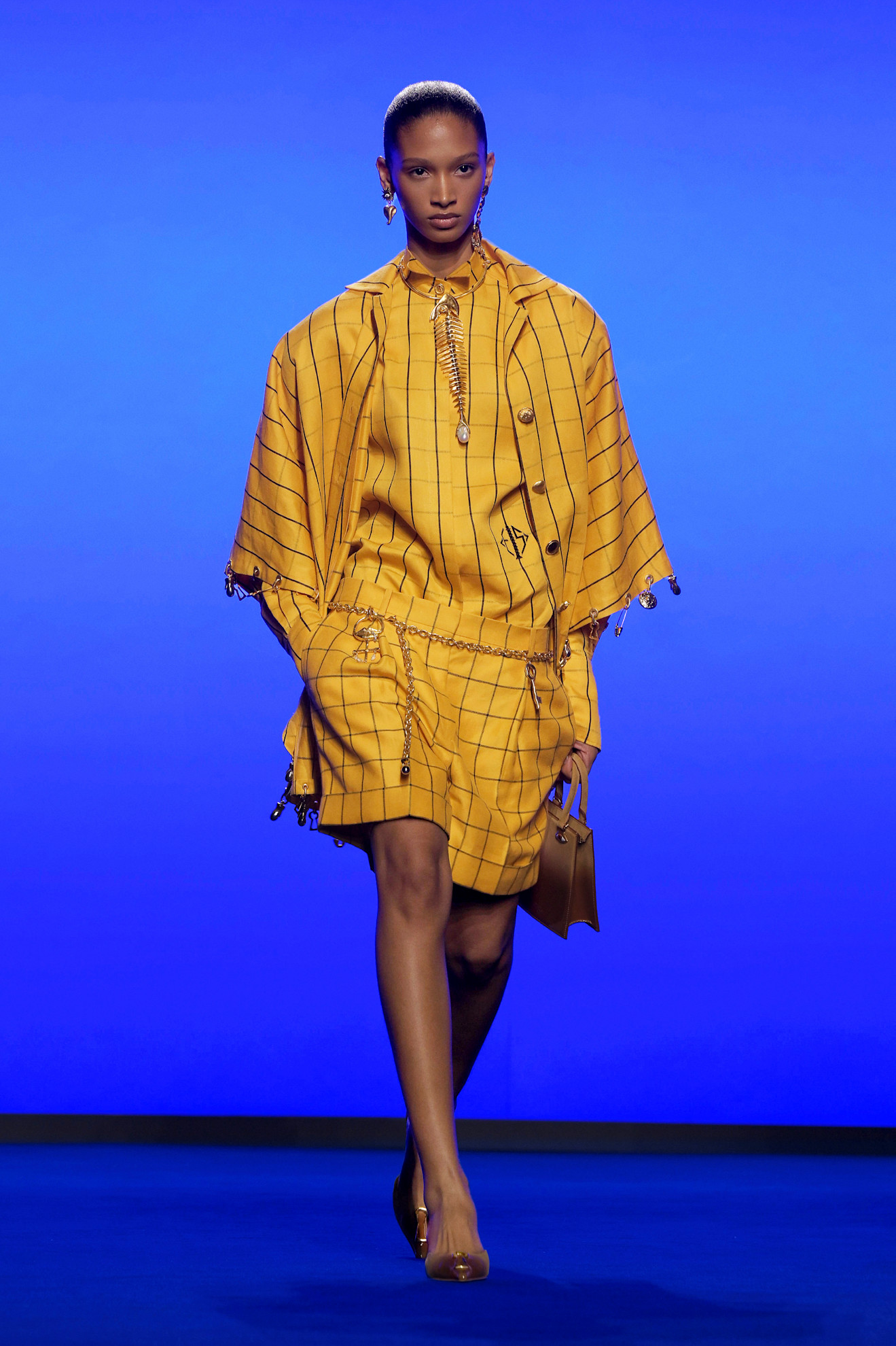 A model wore a turmeric yellow two-piece on the Schiaparelli Spring 2025 runway.