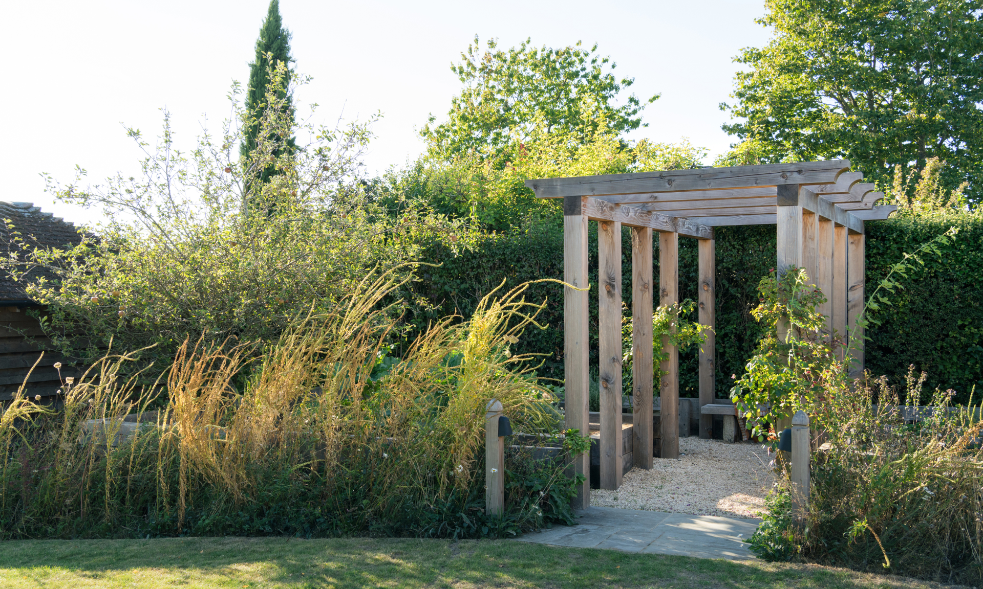 Wooden pergola over gavel path