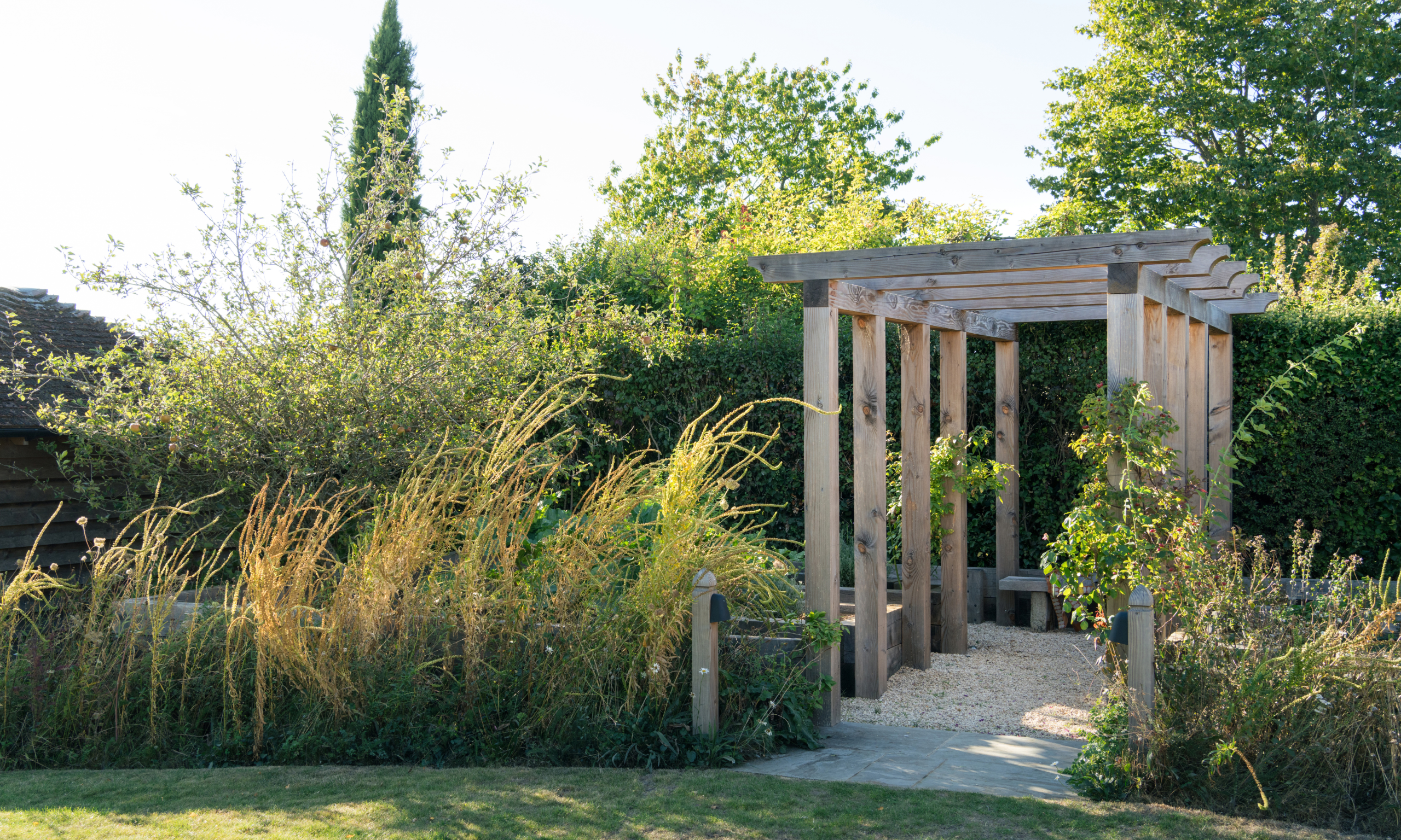 Wooden pergola over gavel path