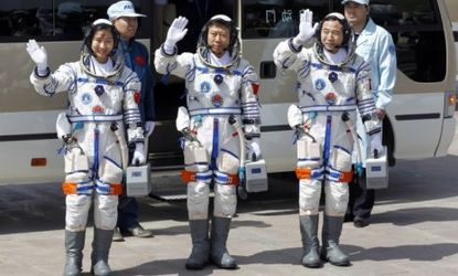 Chinese astronauts, including the country's first female space traveler (left), before liftoff on June 16.