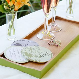 wooden tray with glasses and flower in vase