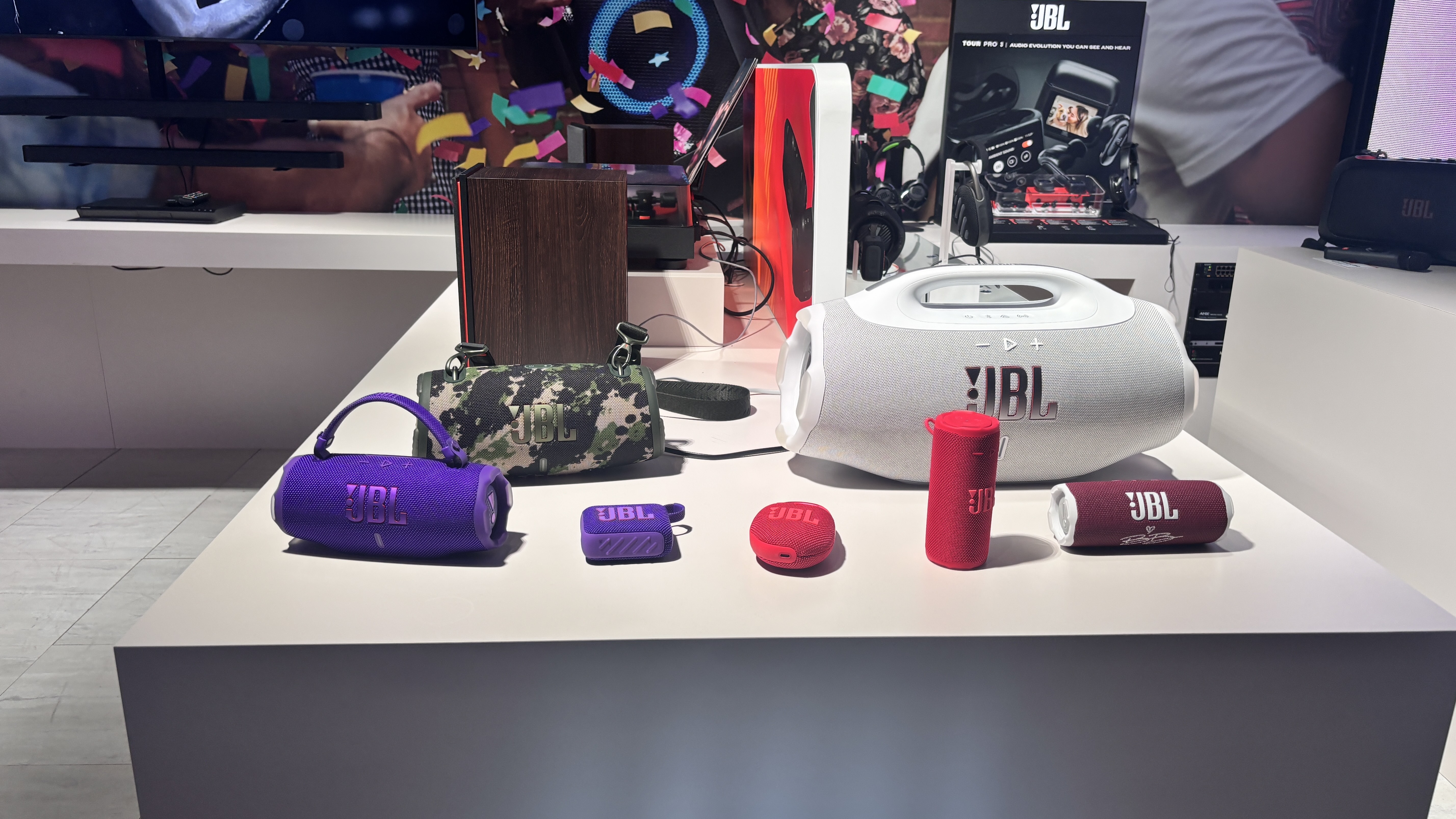 A range of JBL Bluetooth speakers on a JBL branded plinth