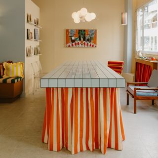 A tiled worktable with a striped skirt