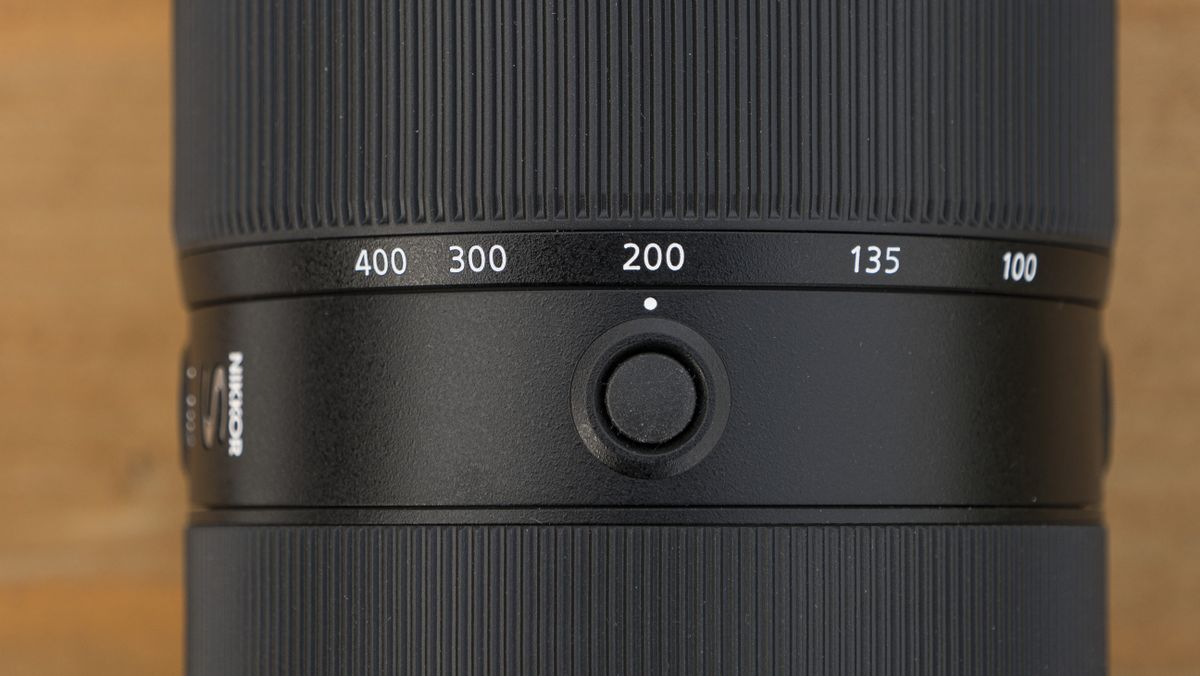 A Nikon Z telephoto lens on a wooden table