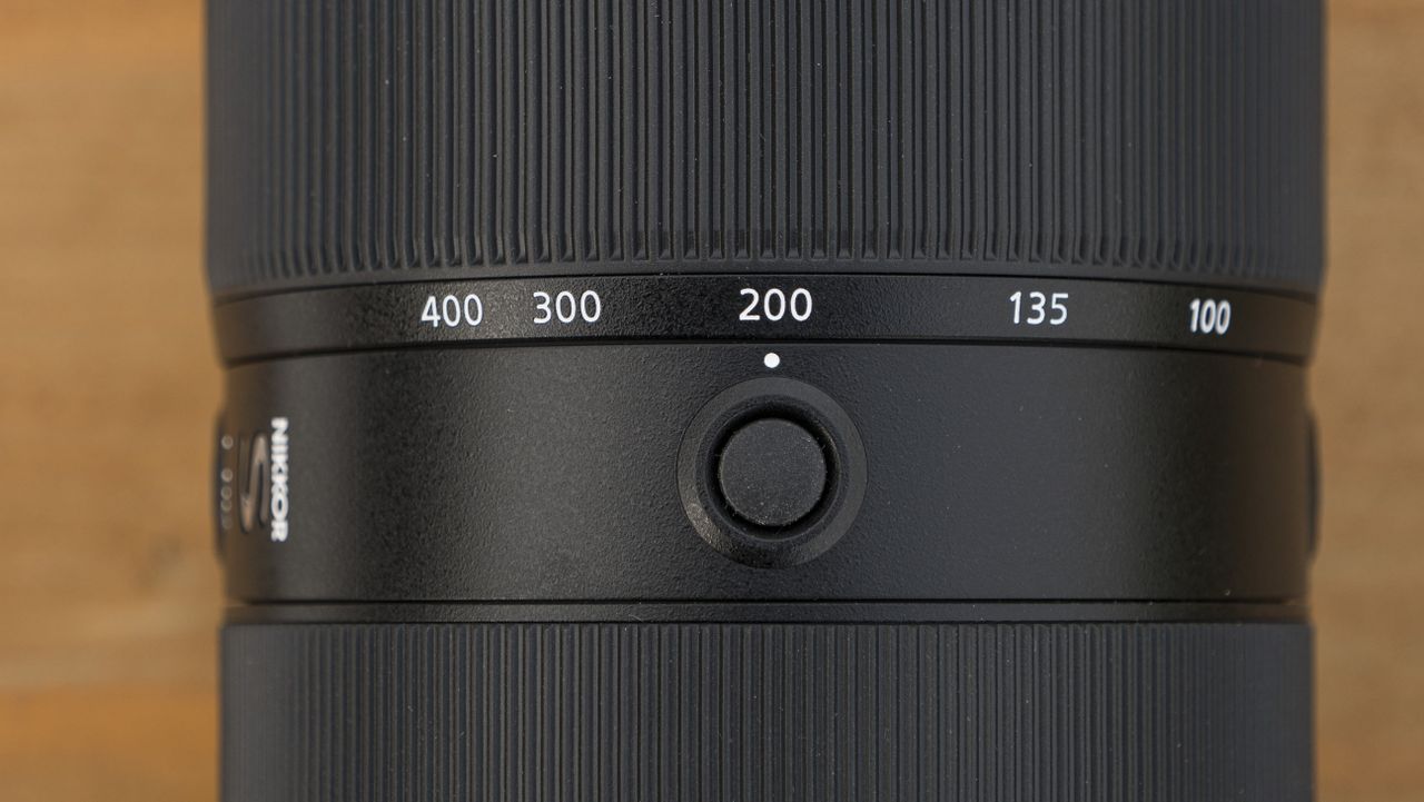 A Nikon Z telephoto lens on a wooden table