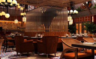 A restaurant with decorated tables, brown chairs, a brown sofa with a glass feature on it and many round pendant lights.