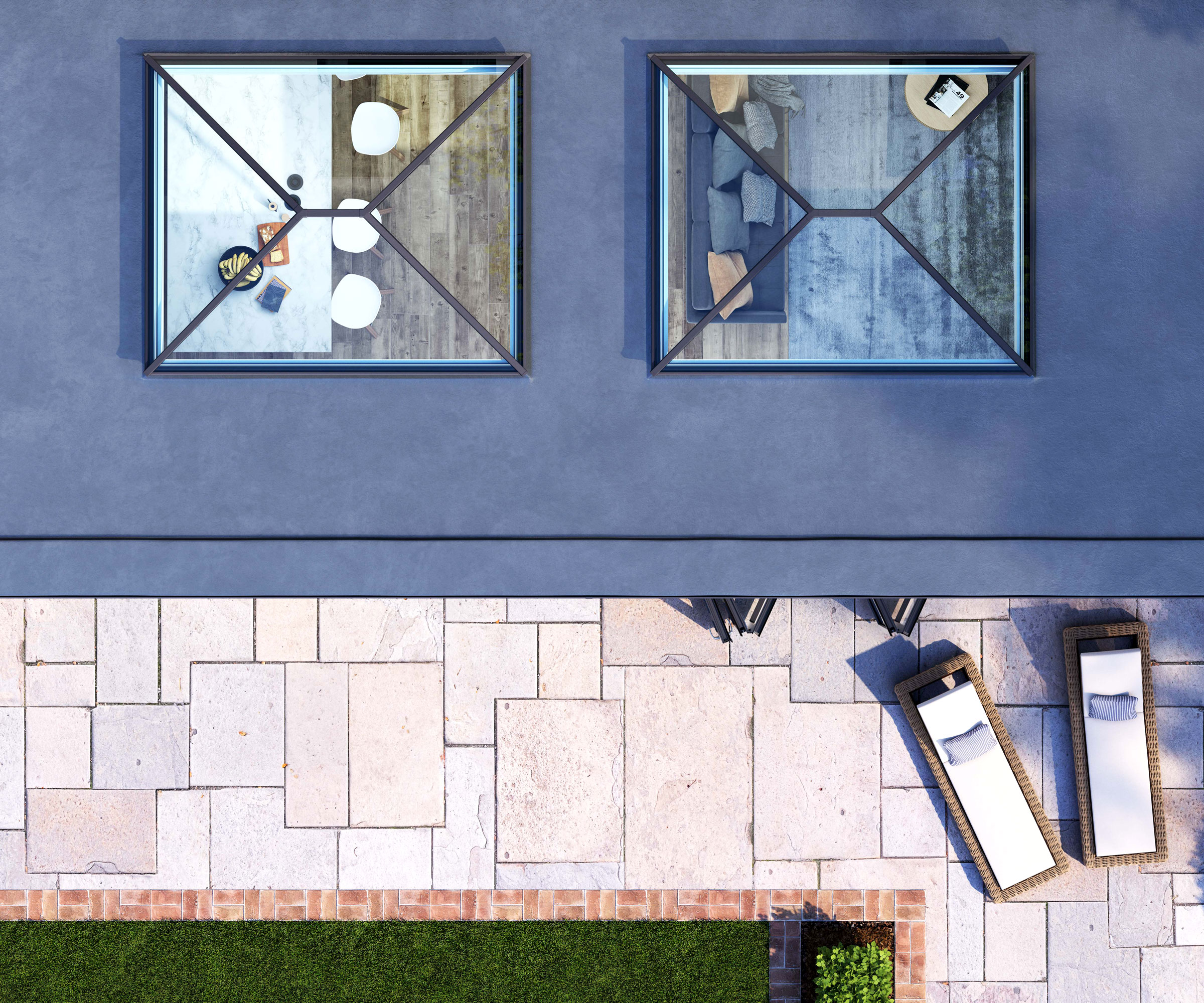 Top down image of two Korniche roof lanterns on roof of large extension with patio and grass