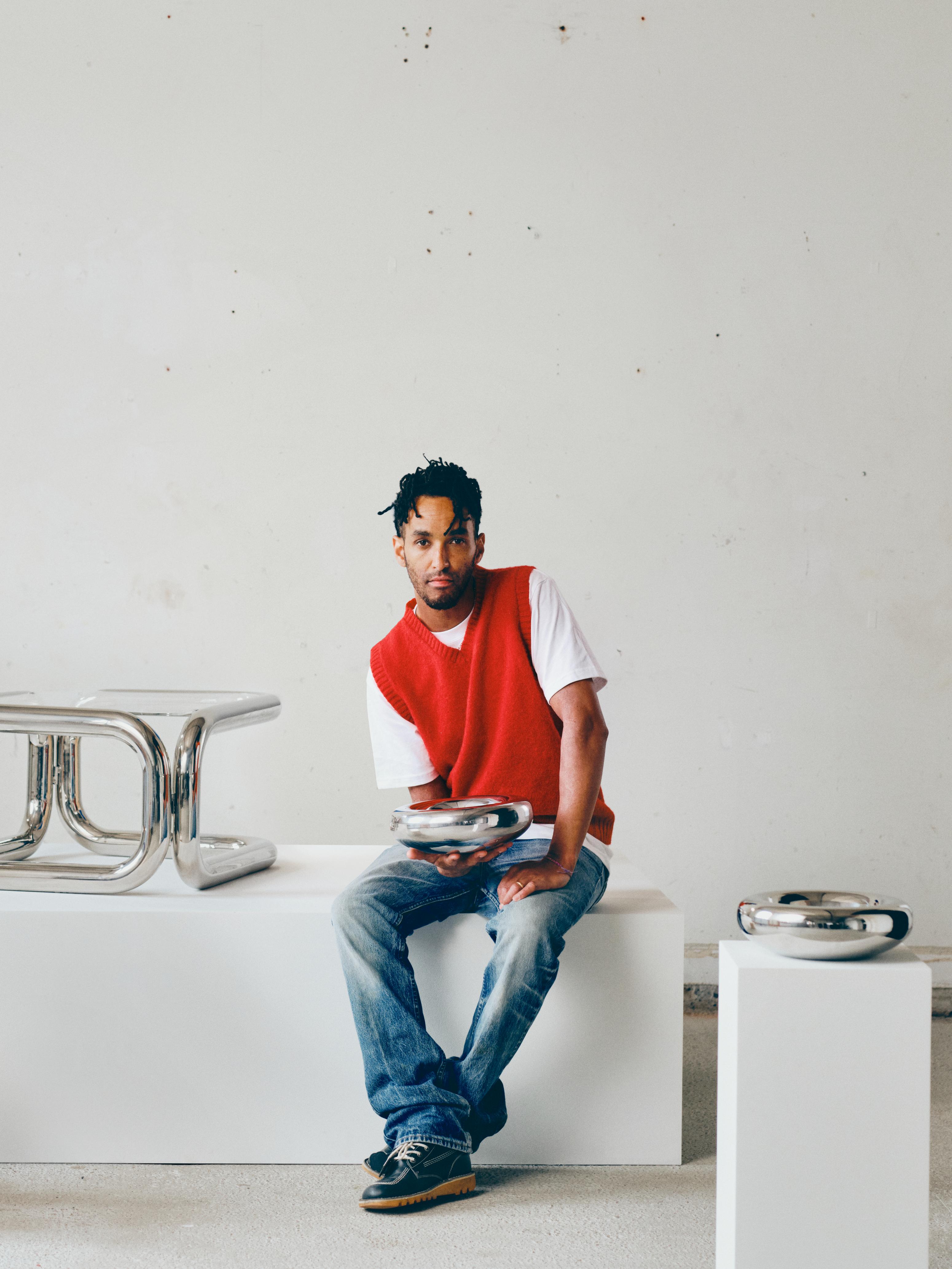 Andu Masebo with stainless steel furniture and objects displayed on plinths