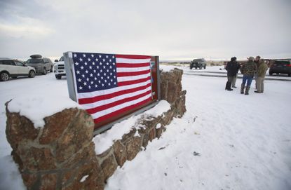 A flag covers a sign at the entrance of the Malheur National Wildlife Refuge