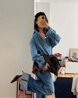 @mimixn taking a mirror selfie wearing denim shirt, cuffed jeans, and black heels