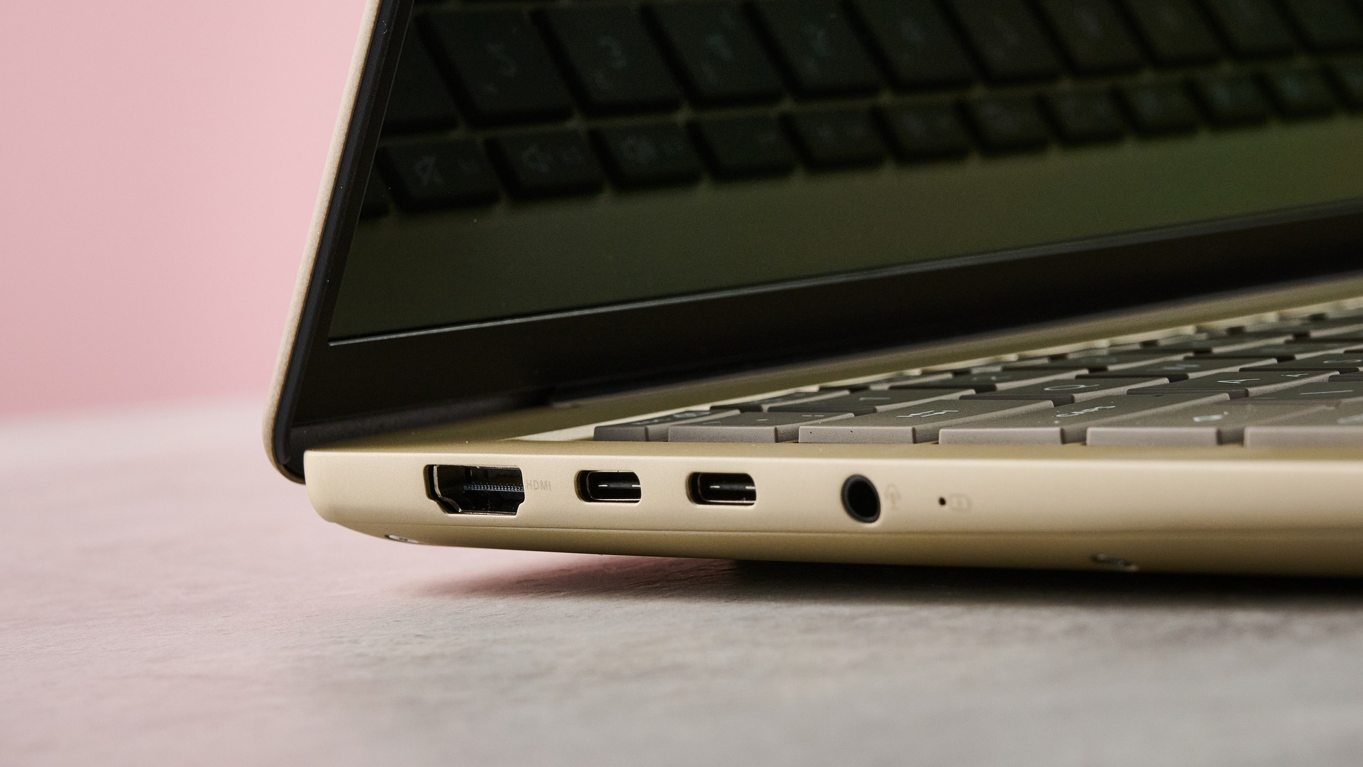 Close-up of ports on left-hand side of Asus Zenbook 14 2026 with pink wall in background