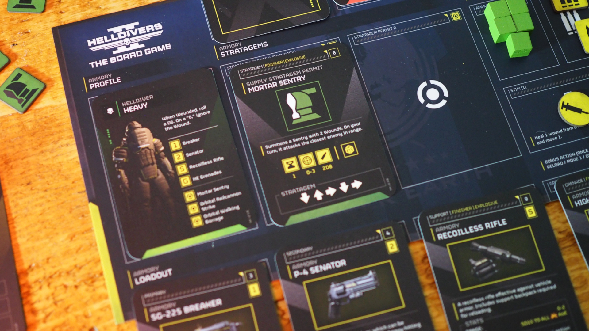 Helldivers 2 board game character sheet with cards and tiles, all sat on a wooden table