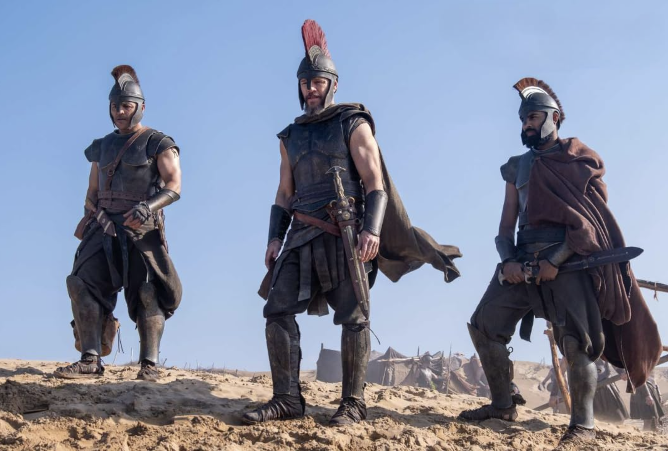 an image from the odyssey showing matt damon as Odysseus in battle gear with two of his men either side of him