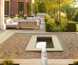 small backyard with gravel and water feature