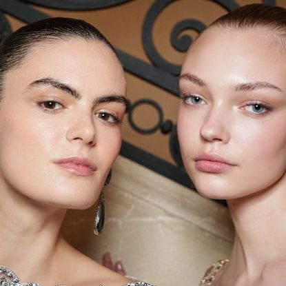 two runway models with glowing skin
