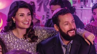 Idina Menzel and Adam Sandler standing together at a party in You Are So Not Invited To My Bat Mitzvah.
