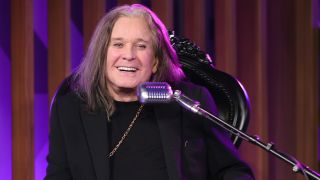 Ozzy Osbourne sat behind a microphone in 2022
