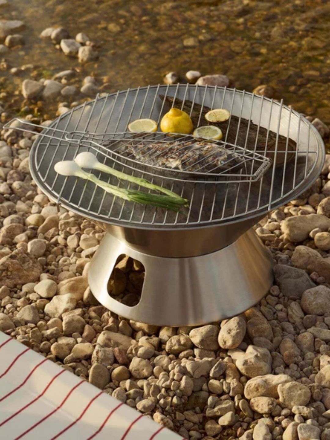 A steel outdoor fire pit and grill from HAY