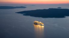 Cruise ship on ocean during sunset