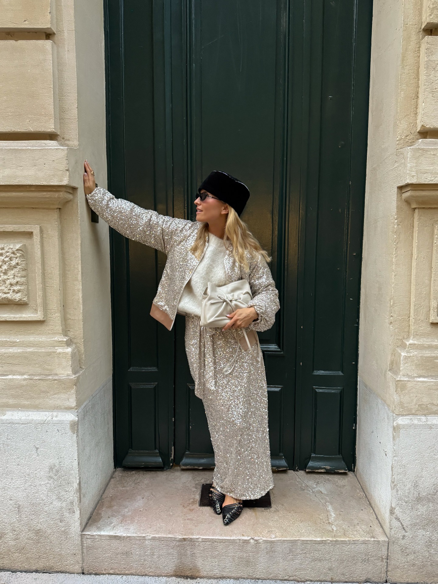 Fashion person Olivia TPs shows what to wear to the pub. She wears a sparkly silver two piece, pointed toe shoes and a pillbox hat.