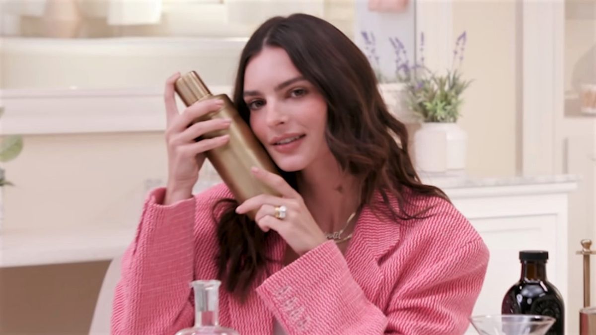 Emily Ratajkowski holding martini shaker in Who&#039;s In My Bathroom? with Hailey Bieber