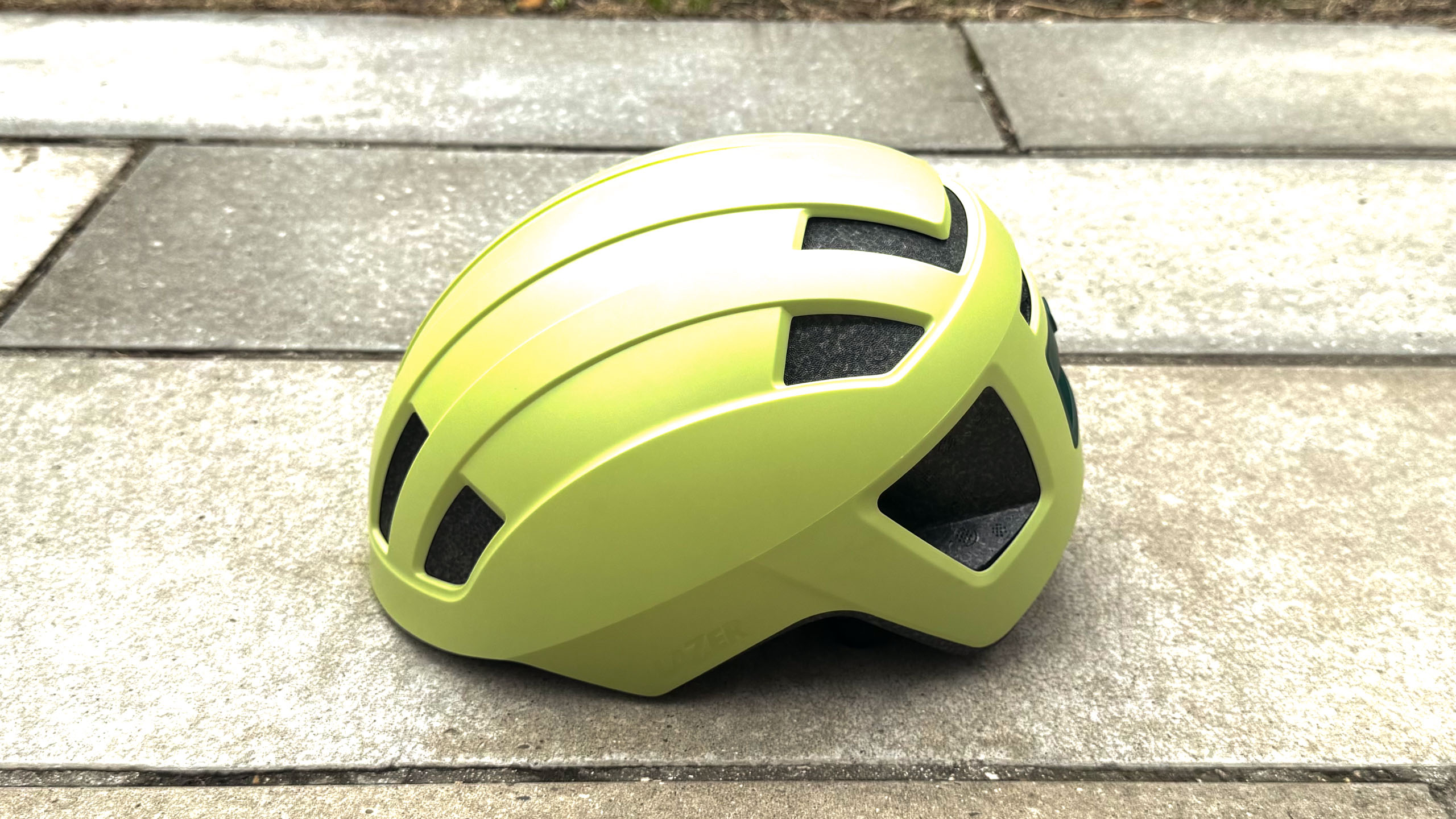 The Lazer Verde e-bike helmet on a stone floor