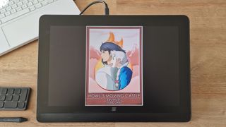 A photo of a poster on the screen of a large drawing tablet