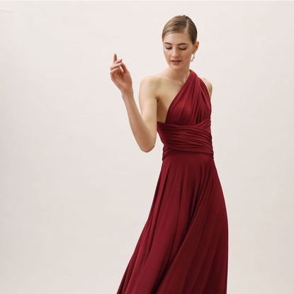 Dress, Fashion model, Clothing, Gown, Shoulder, Red, Formal wear, Standing, Bridal party dress, Maroon,