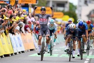 PAU FRANCE JULY 12 LR Jasper Philipsen of Belgium and Team Alpecin Deceuninck celebrates at finish line as stage winner ahead of Wout Van Aert of Belgium and Team Visma Lease a Bike during the 111th Tour de France 2024 Stage 13 a 1653km stage from Agen to Pau UCIWT on July 12 2024 in Pau France Photo by Dario BelingheriGetty Images