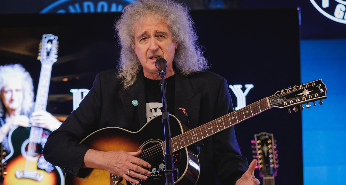 Brian May holds his new signature SJ-200 12-string as he addressed the audience at the Gibson Garage London