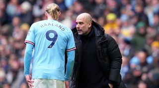 Manchester City manager Pep Guardiola gives instructions to striker Erling Haaland