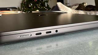 A Space Black Apple MacBook Pro 16-inch M3 sitting on a grey/blue table