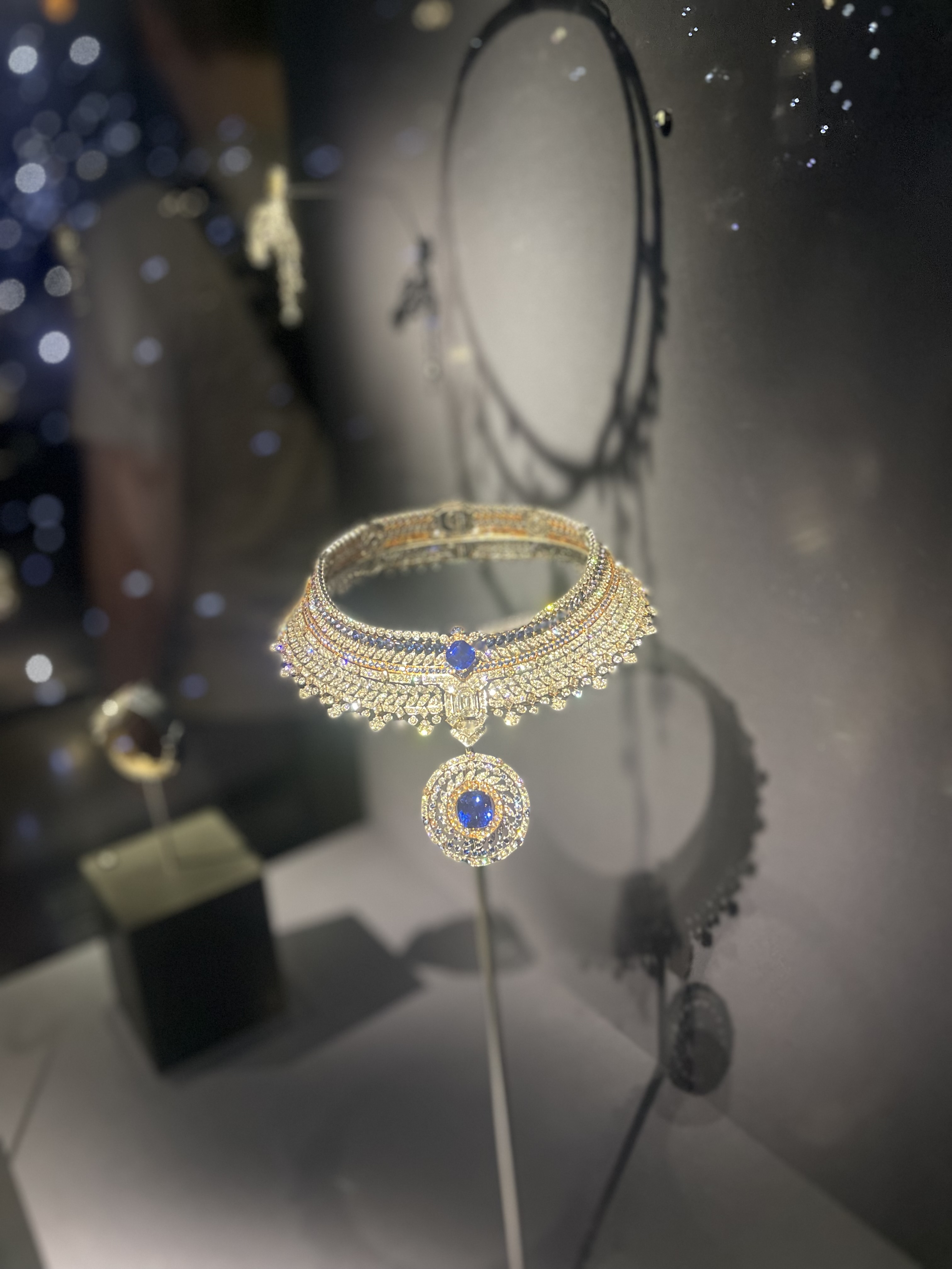 A sparkling choker with white and blue stones.