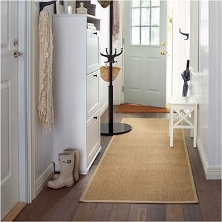 rug on wooden floor and white wooden door