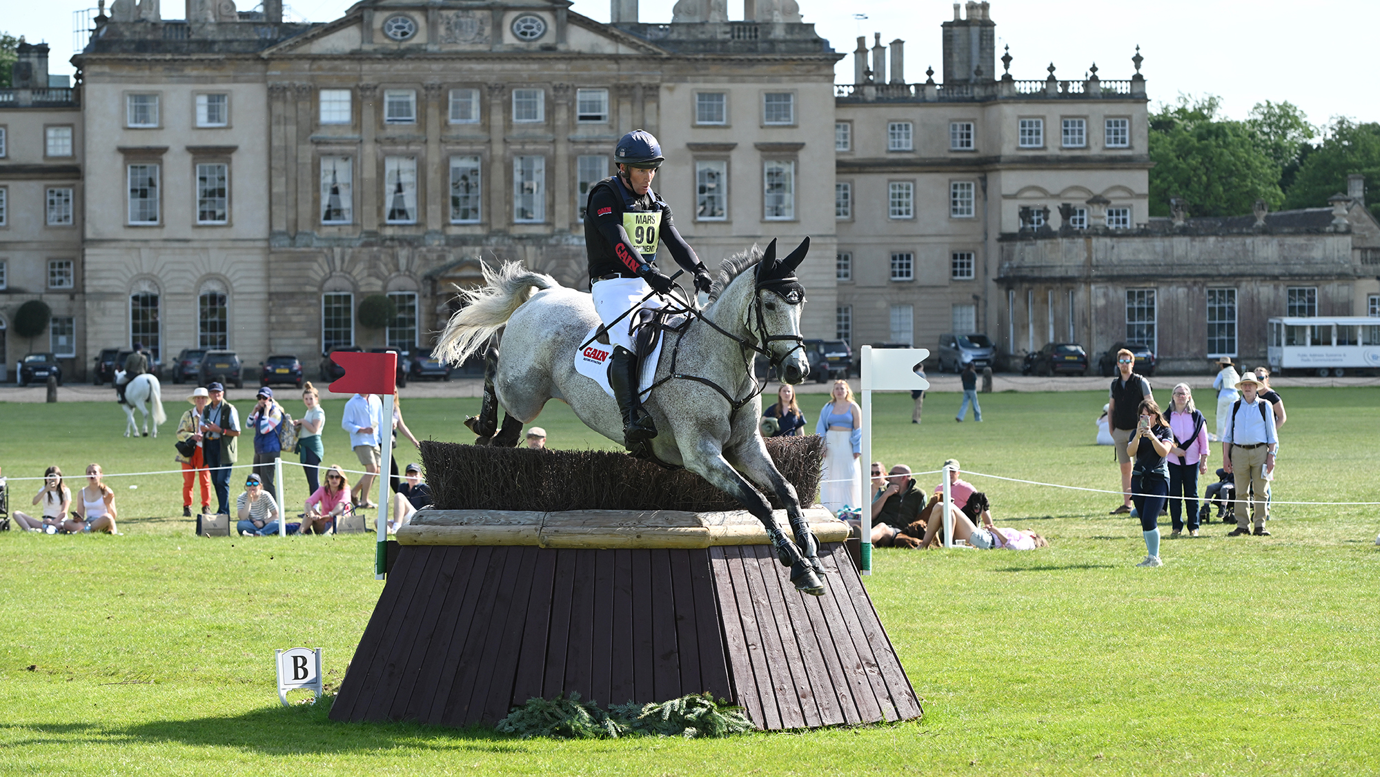 Oliver Townend and Cooley Rosalent jump a cross-country fence in front of the house at Badminton Horse Trials 2025.