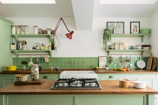 A mint kitchen with wooden island surface
