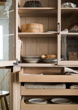 a close up of a wooden kitchen cabinet's contents