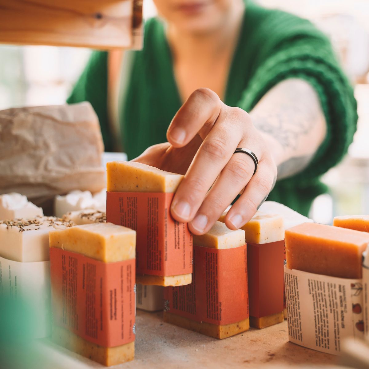 woman leaning into to grab a bar of soap -sustainable beauty